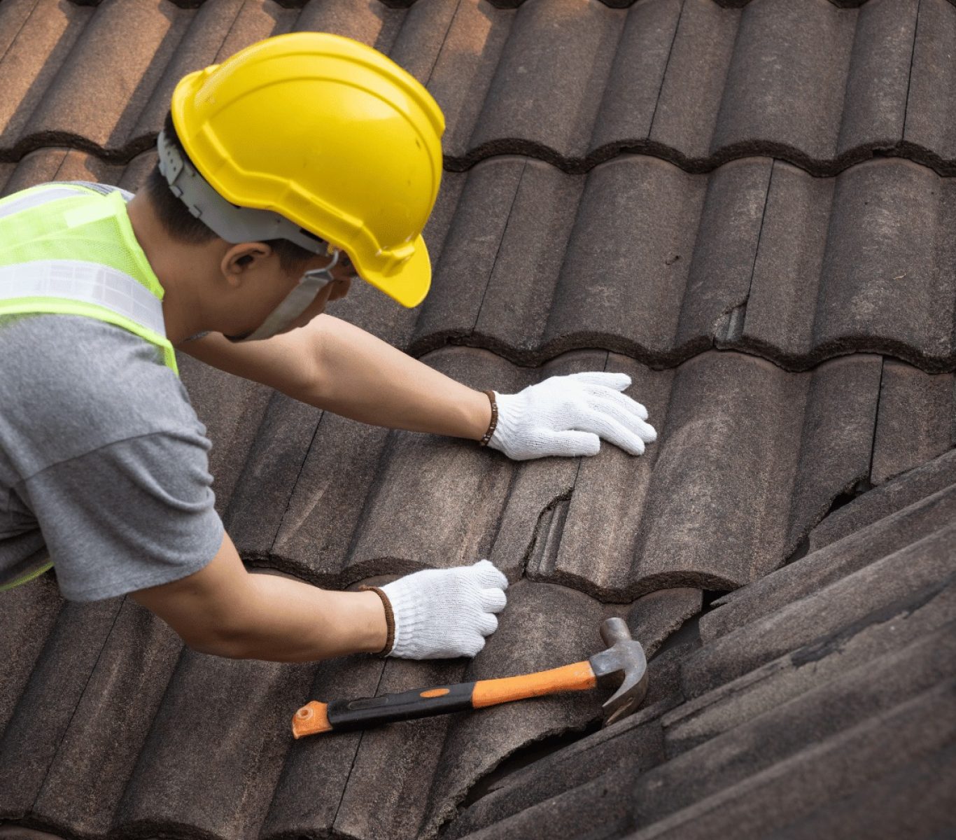 Crew removing old shingles during a Nebraska roof replacement