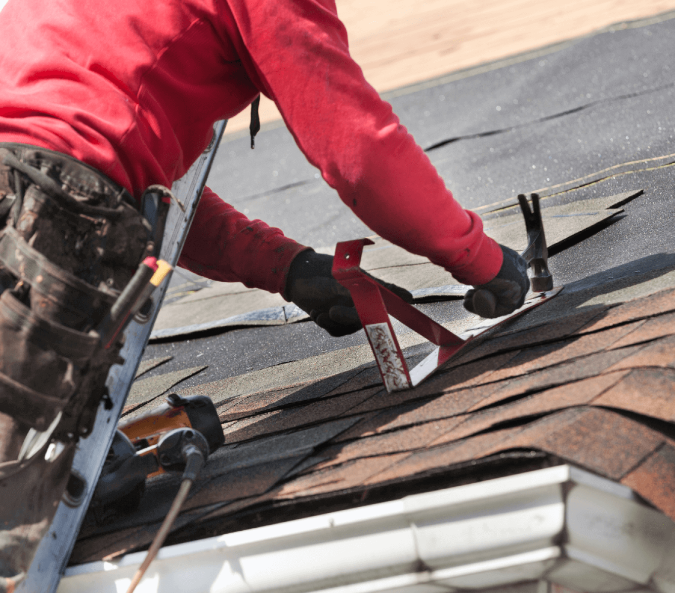 Technician replacing damaged shingles on Nebraska home