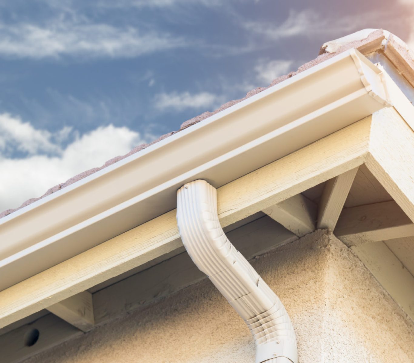Crew installing seamless aluminum gutters on a home in Nebraska