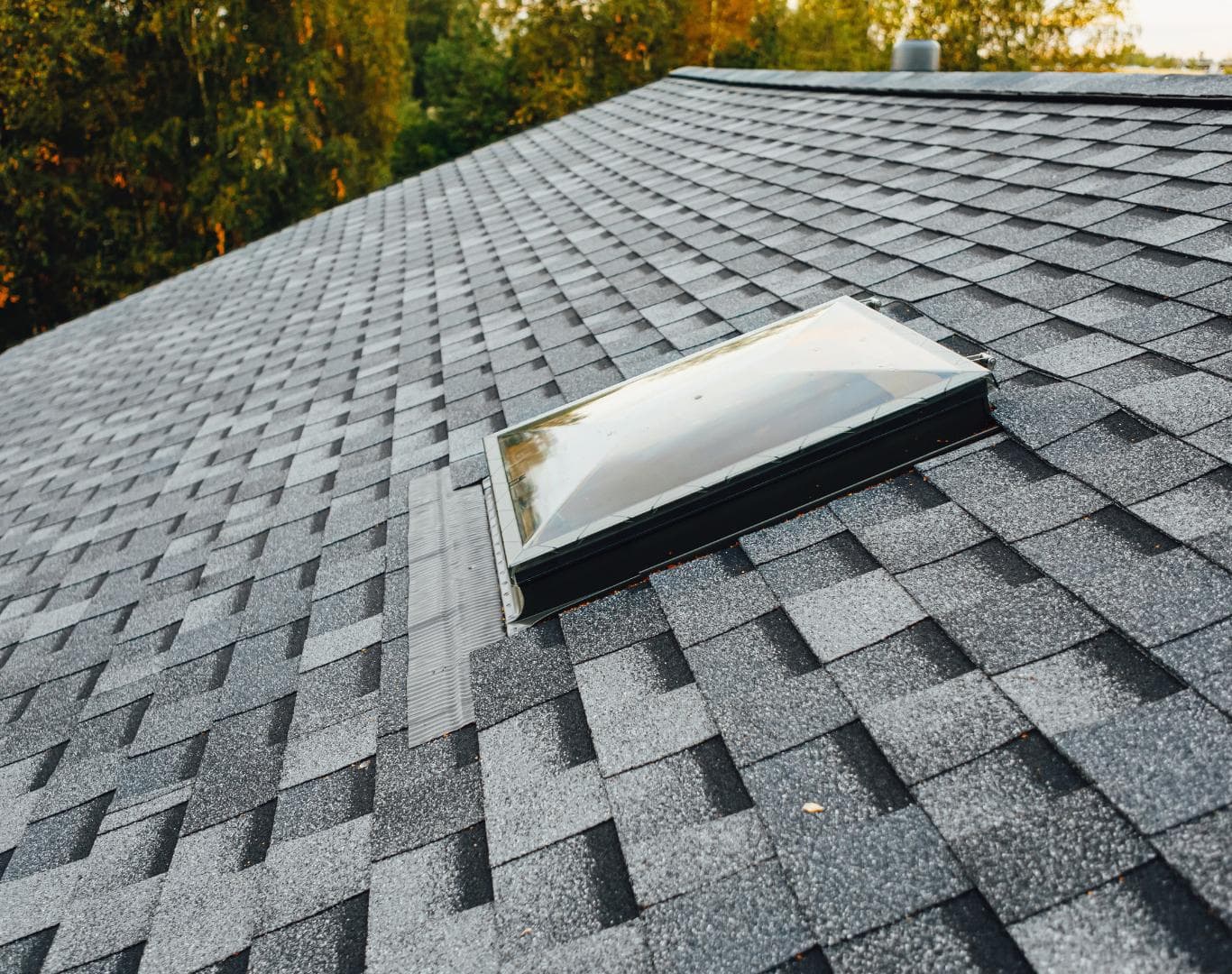 Close-up of asphalt shingles and skylight flashing on an Omaha, NE roof