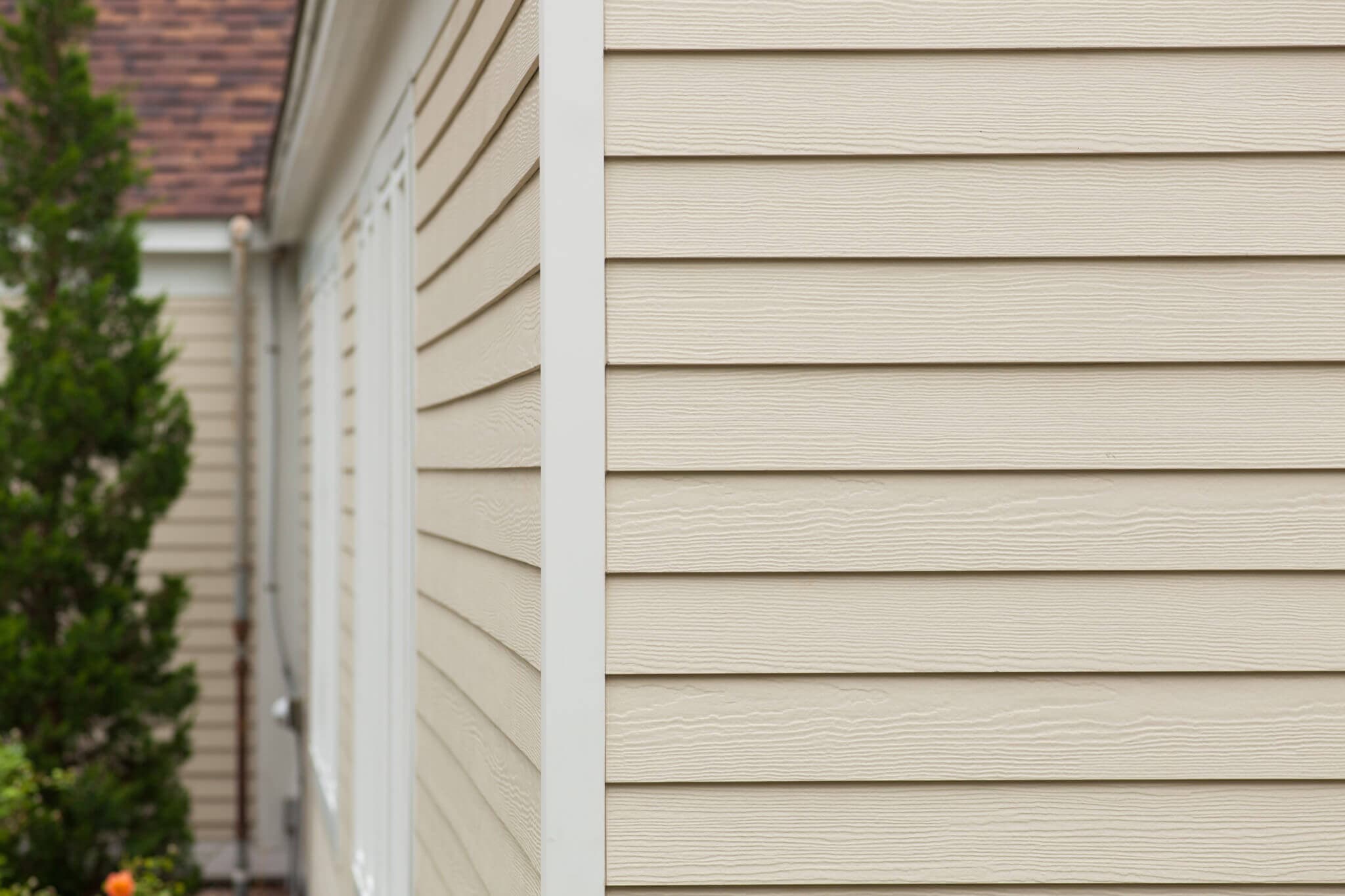 Painted fiber cement siding on a Nebraska home next to trim and window flashing