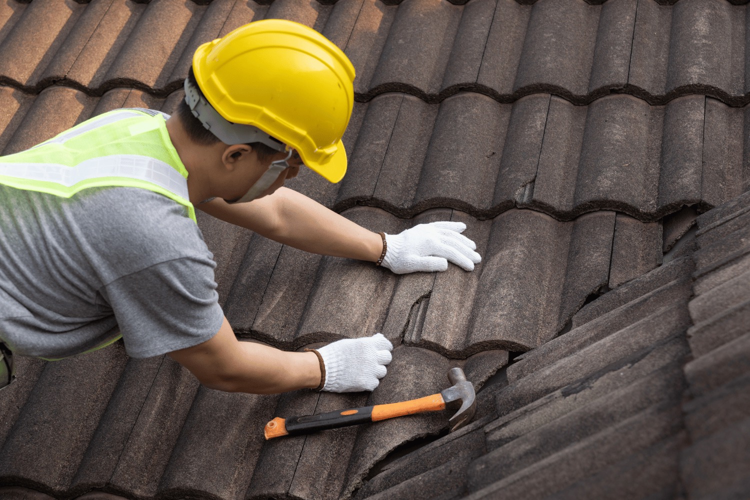Crew removing old shingles during a Nebraska roof replacement