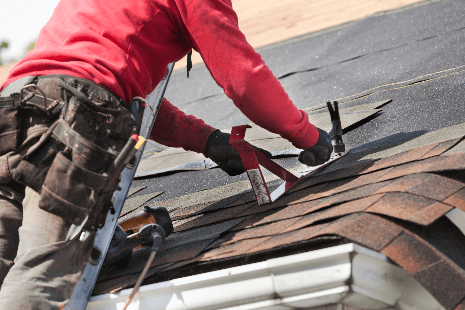 Technician replacing damaged shingles on Nebraska home