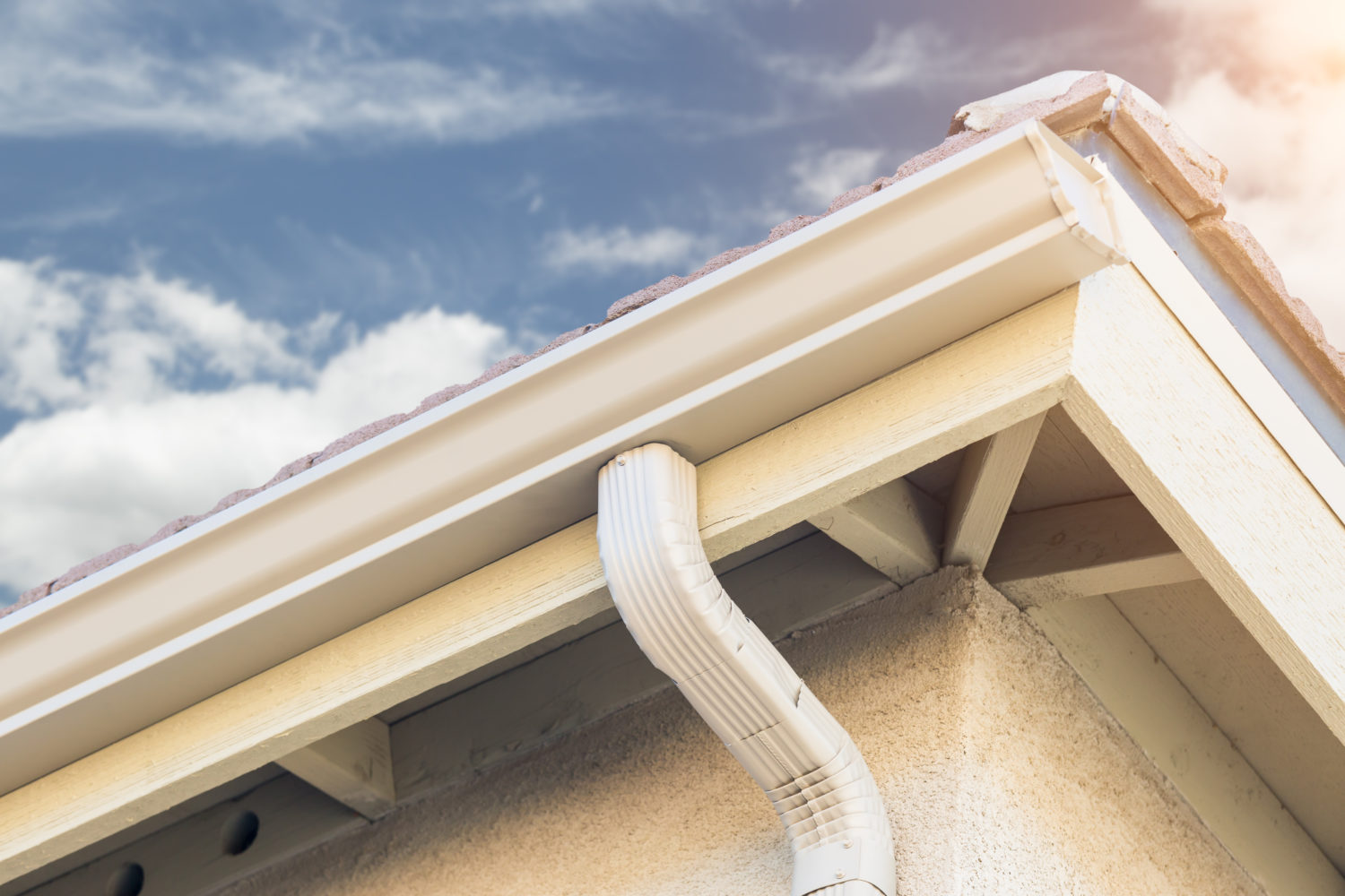 Crew installing seamless aluminum gutters on a home in Nebraska