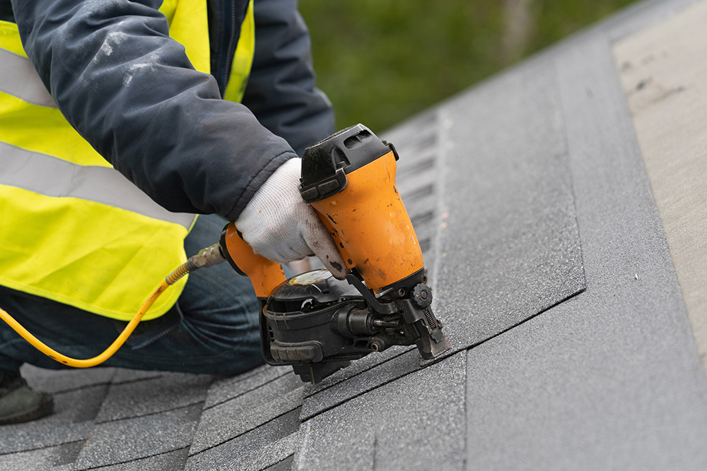 Kutsch Roofing team working on hail-damaged roof