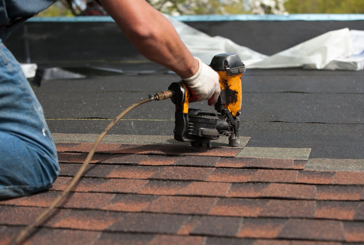 Technician replacing damaged shingles on Nebraska home